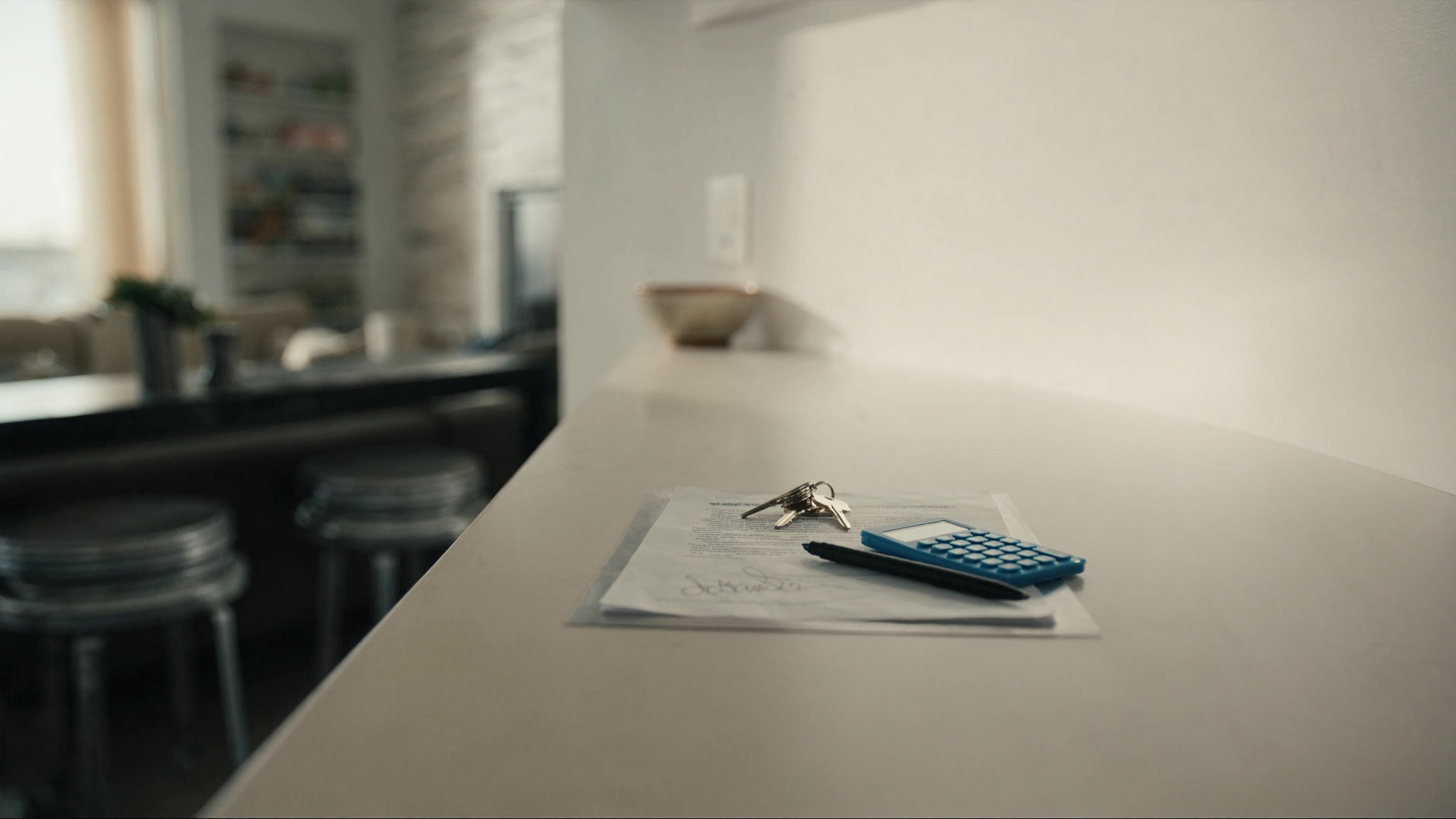Purchase agreement and house keys on a counter in a new condo