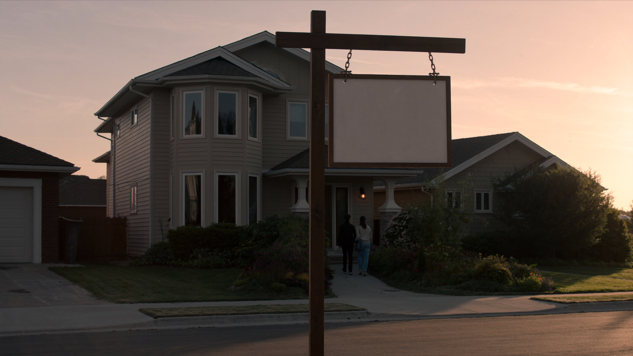 New detached home in Ontario at sunset with a blank sign post out front