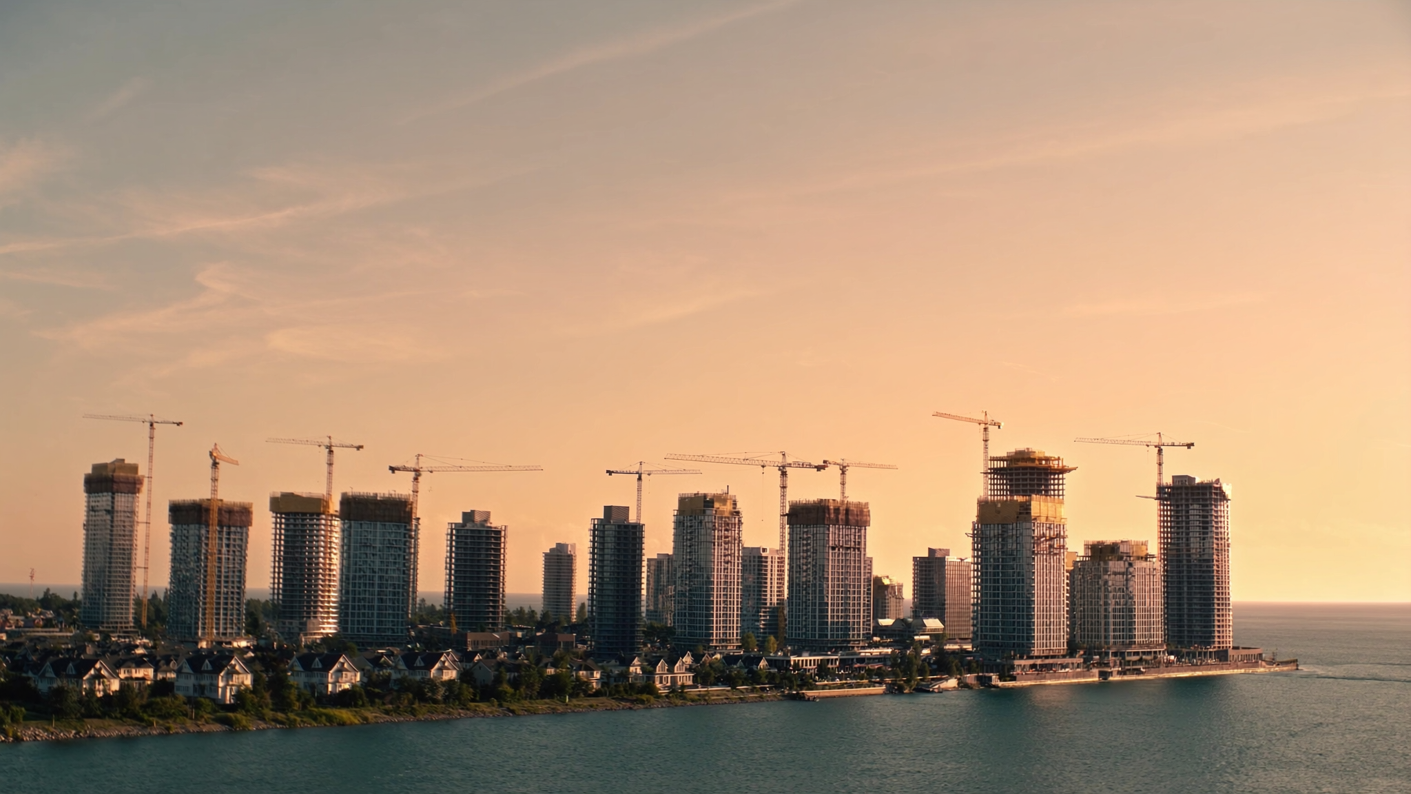 Toronto skyline with new condo towers and construction cranes at golden hour