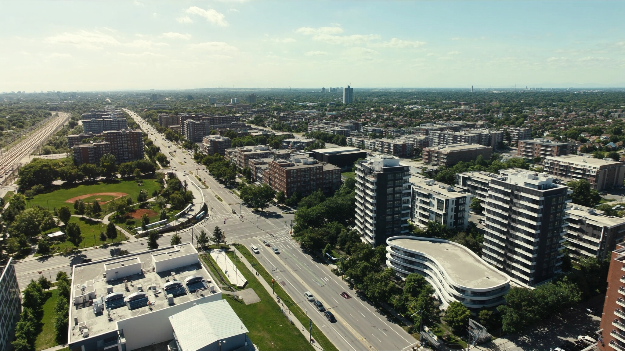 Aerial view of a new transit-oriented GTA neighbourhood with mid-rise condos and a park