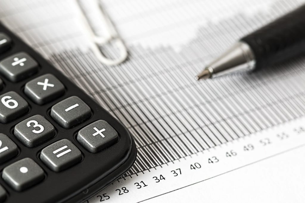 Calculator and pen on a paper.
