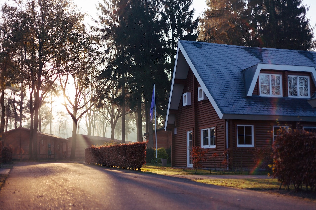 Beautiful country home with light coming through nearby trees.
