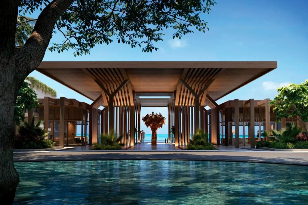 Elegant entrance of Vie L'Ven luxury resort with a symmetric wooden pathway leading to a serene pool overlooking the ocean in St. Maarten.