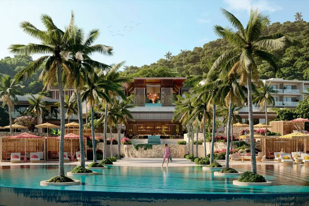 Lavish poolside area of Vie L'Ven featuring private cabanas and tropical palm trees set against a backdrop of luxury residences in St. Maarten.