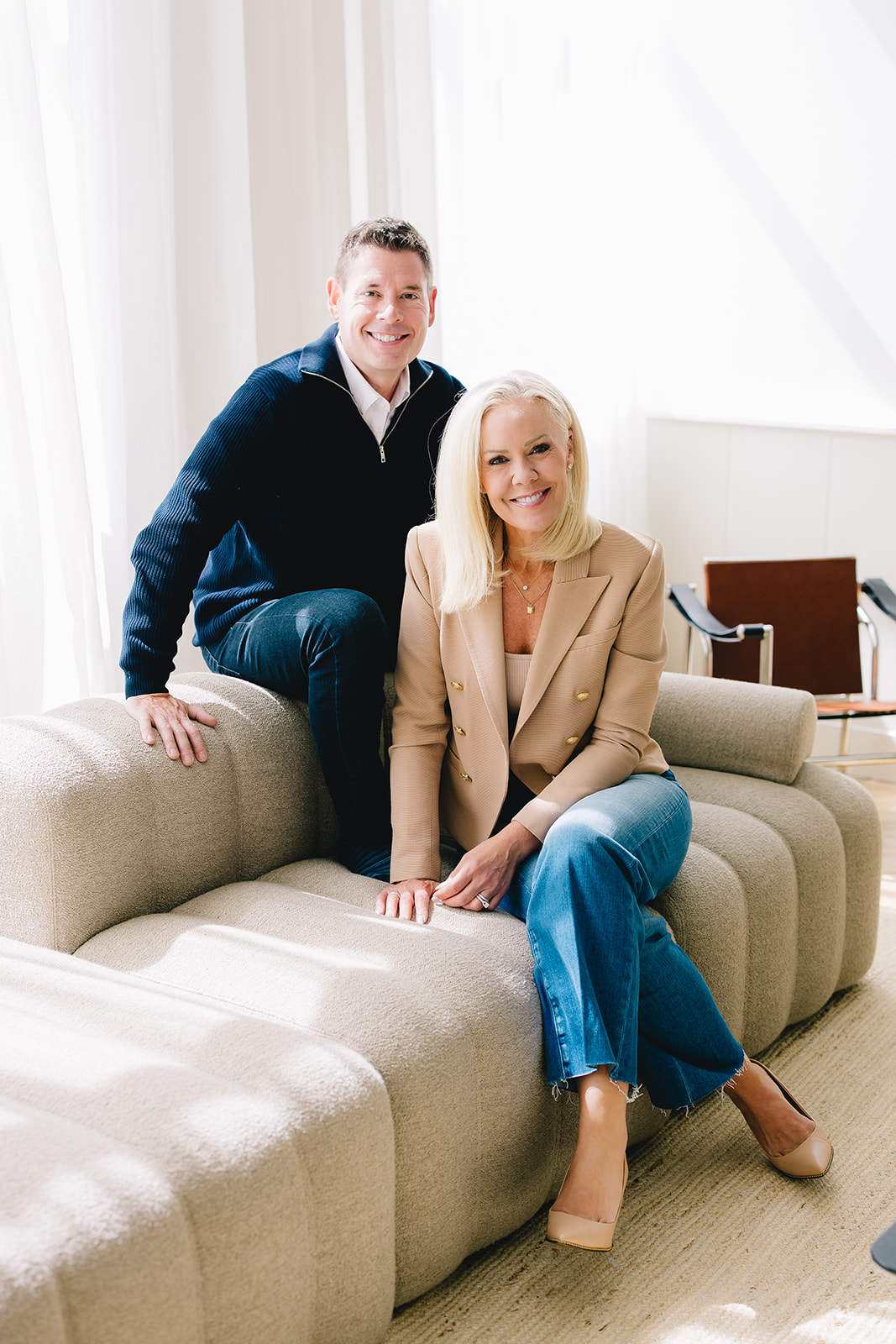 Candice and Jason Schott sitting together on a sofa